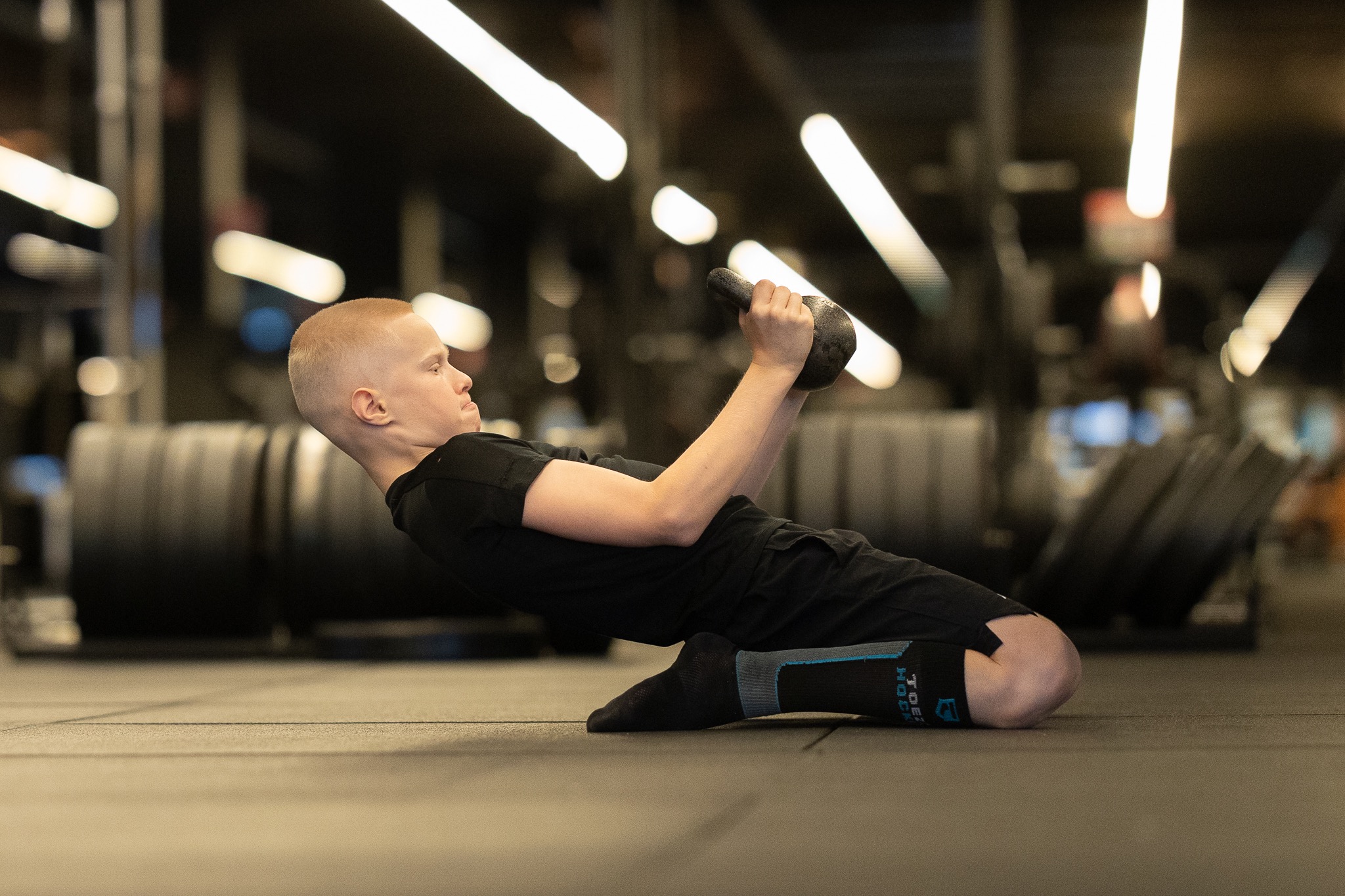Athlete building strength through a deep range of motion with a kettlebell